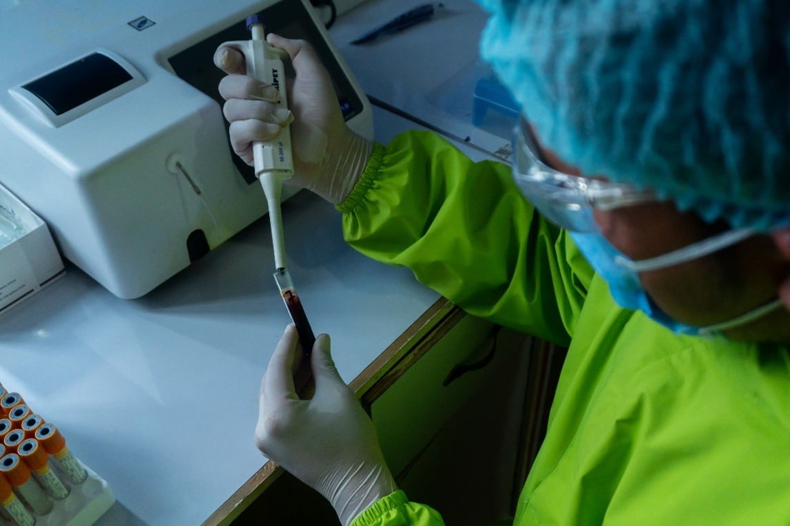 photo of a worker in a laboratory running a test