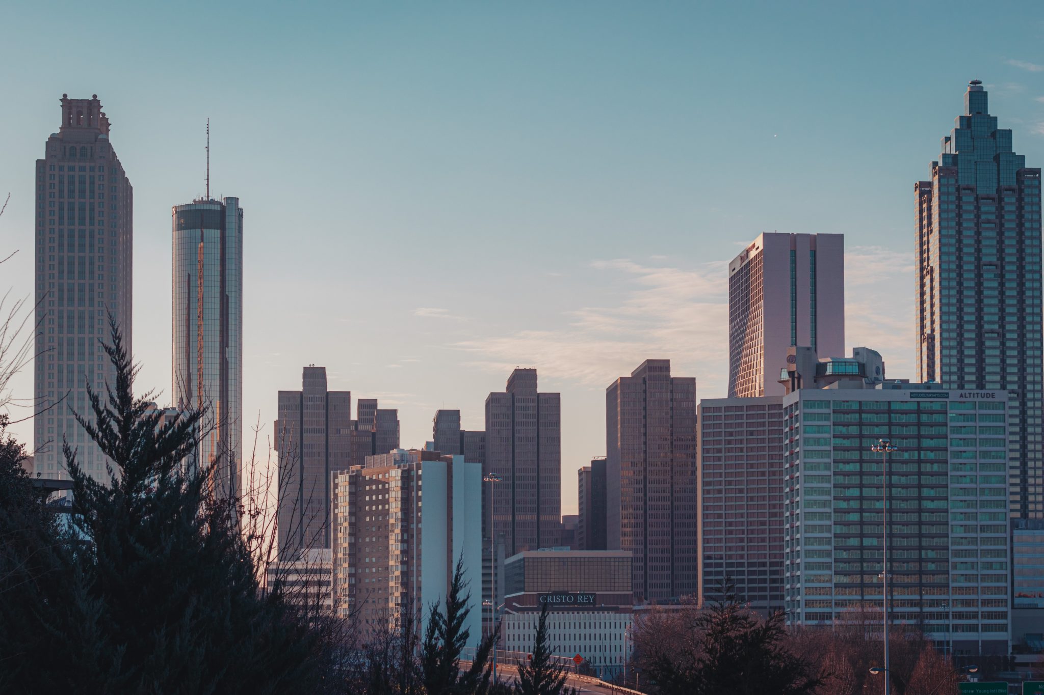 Photo of tall buildings in Atlanta against a light blue sky