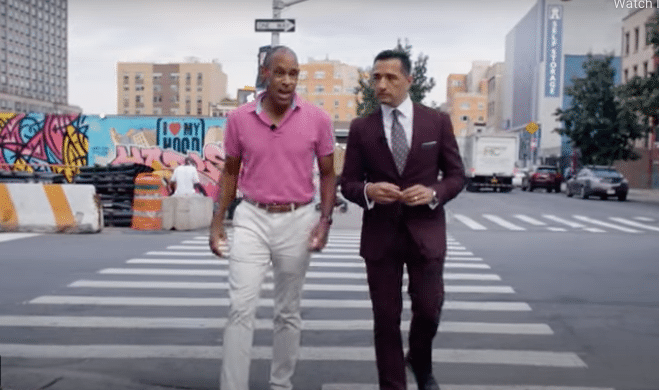 Michael Sneed and Dr. Adam Aponte speak while walking in a crosswalk