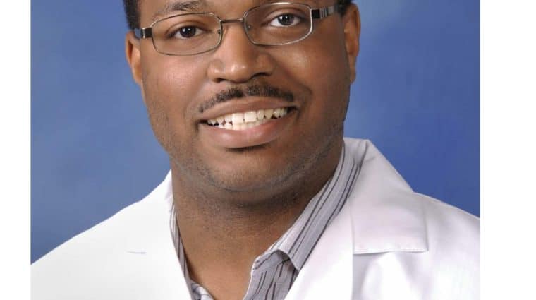 Headshot of Dr. Britt Gayle wearing a white doctor's coat