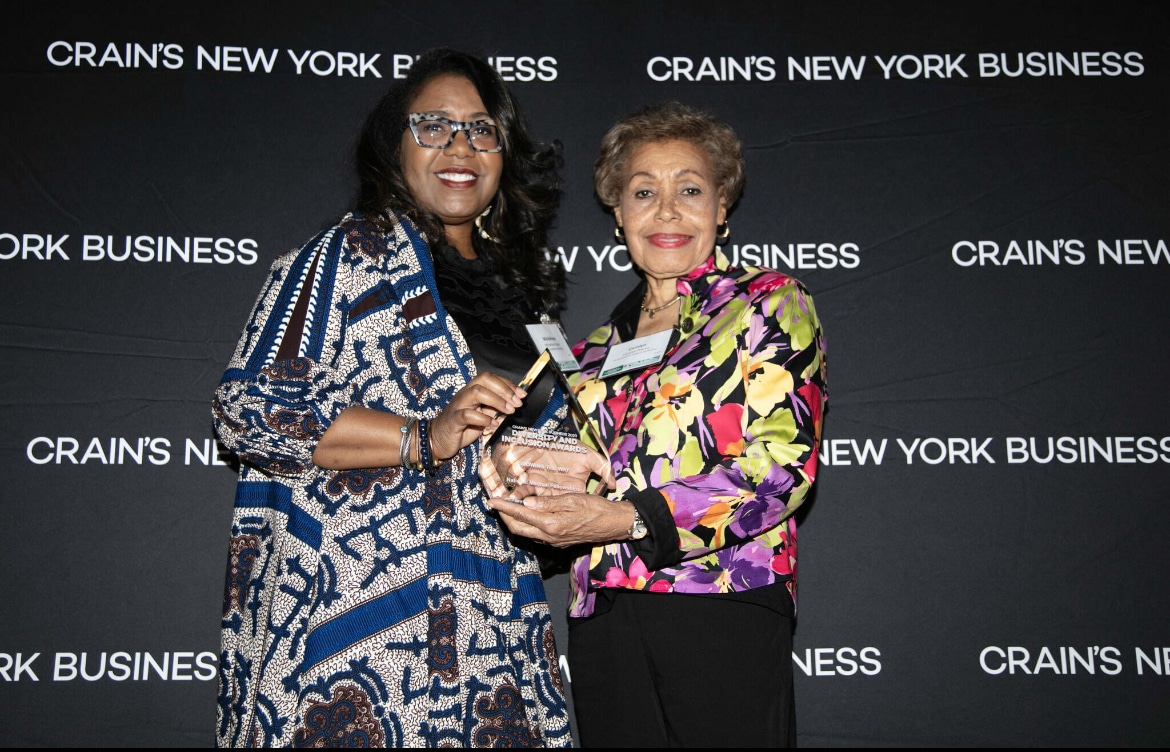 Michellene Davis accepting an award from Crain's New York Business