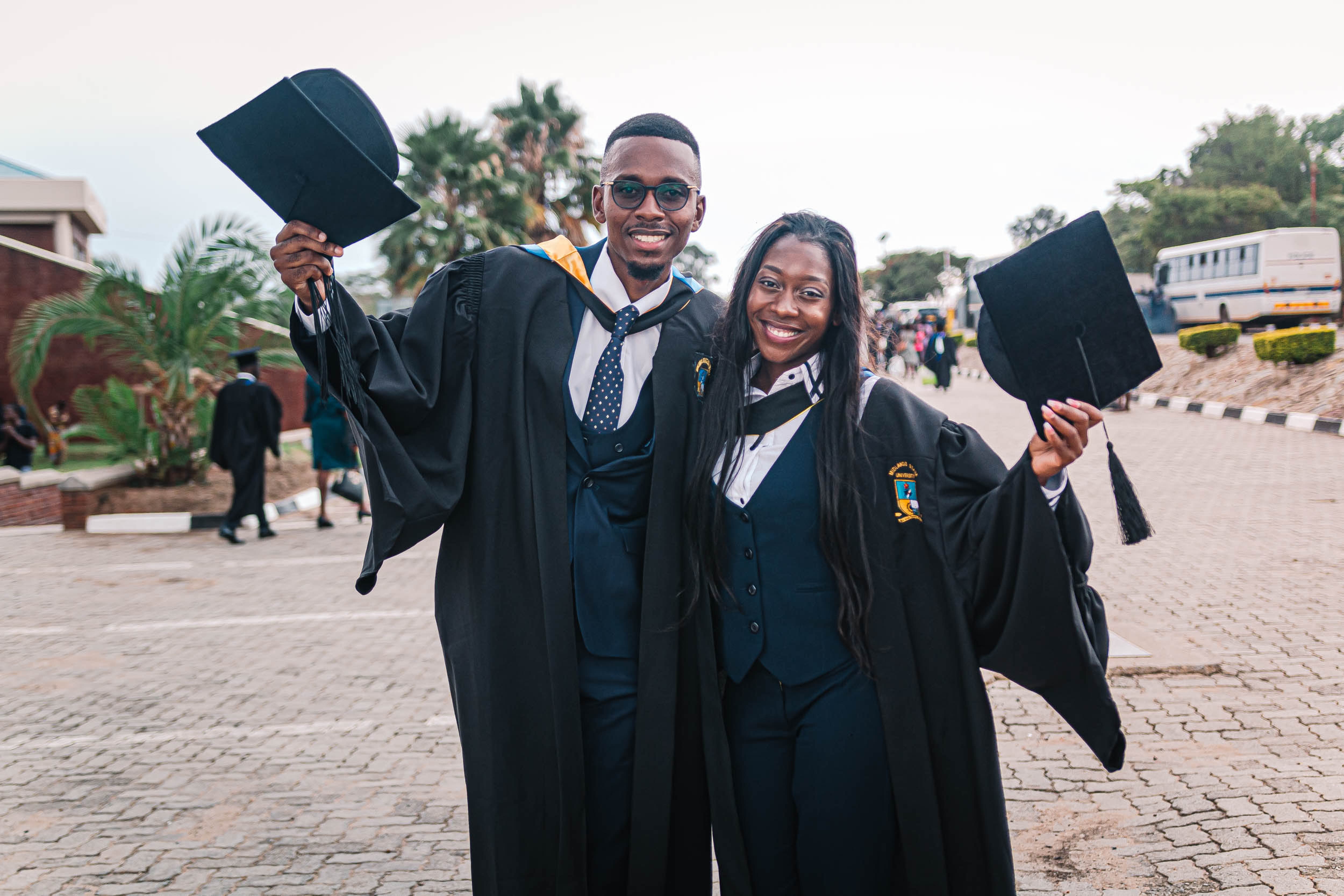 Two black students celebrating graduation