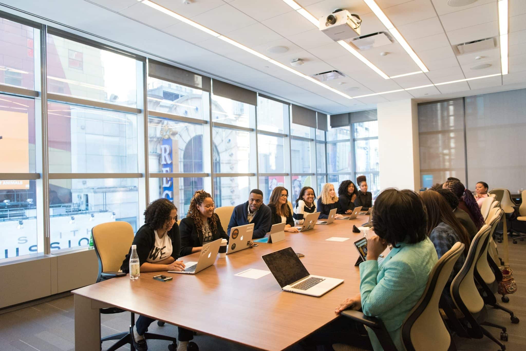 Many students seated at a long table engaging in professional development