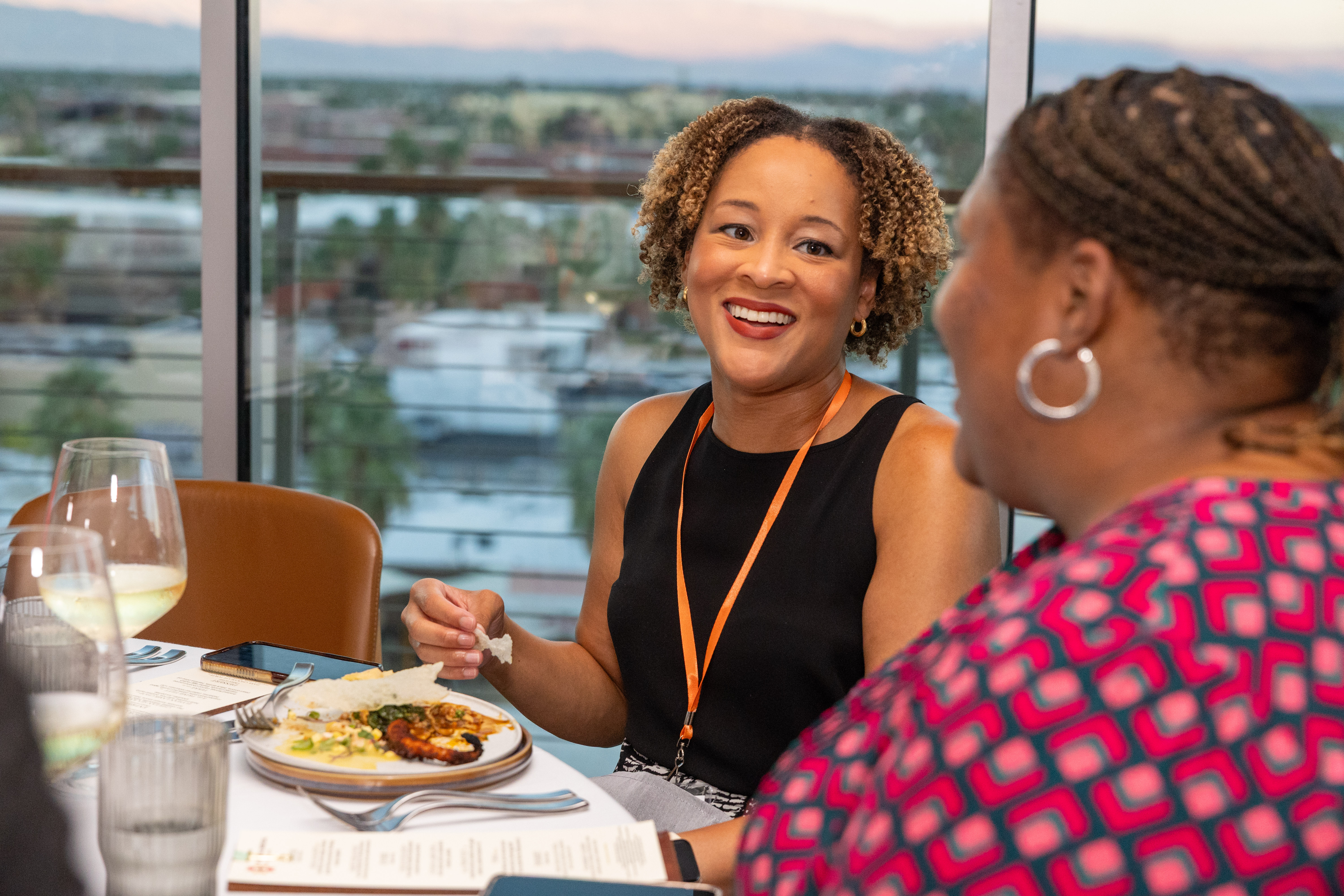 Photo of two women eating and chatting