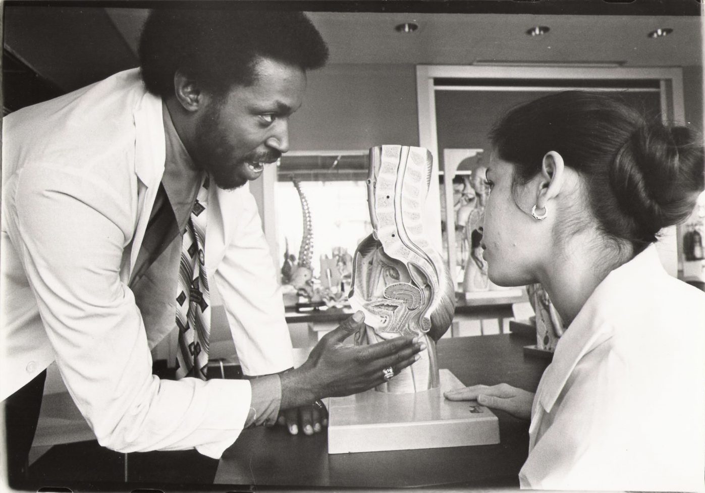 A photo of Dr. Lawrence Brown, Jr. working in a clinical setting with a colleague.
