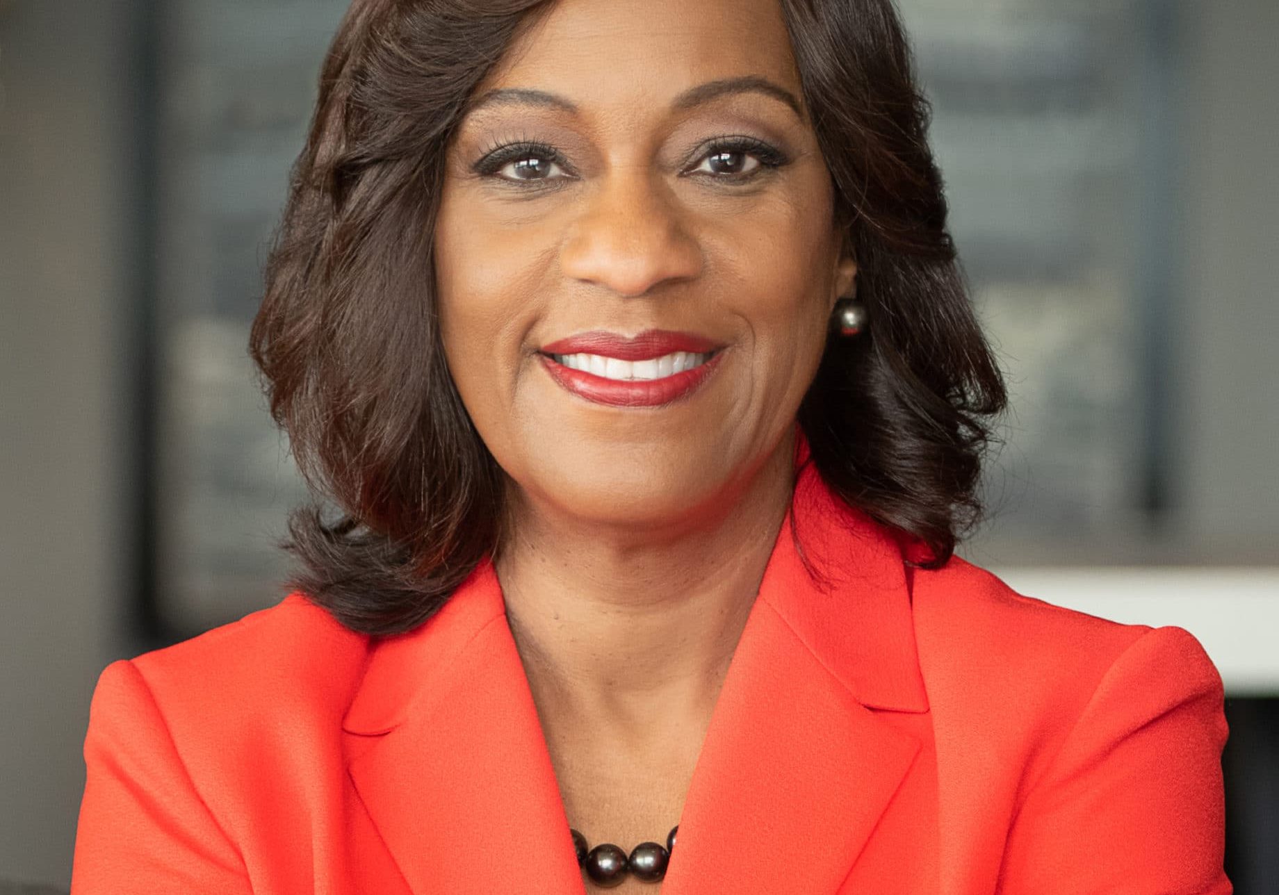 Photo of Dr. Sandra B. Nichols wearing an orange blazer.